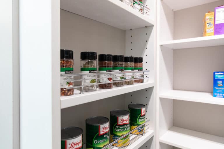 Various food and beverage boxes and spices neatly stored in a custom kitchen pantry