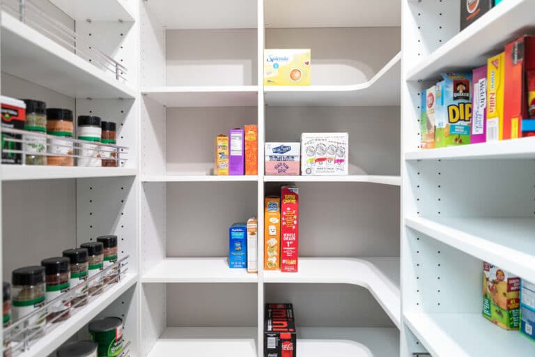 Various food and beverage boxes neatly stored in a custom kitchen pantry