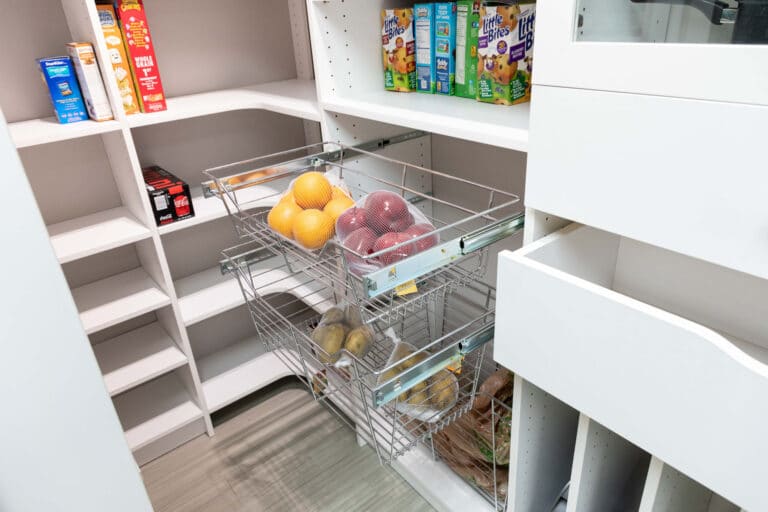 A kitchen pantry custom storage design with drawers and door opened