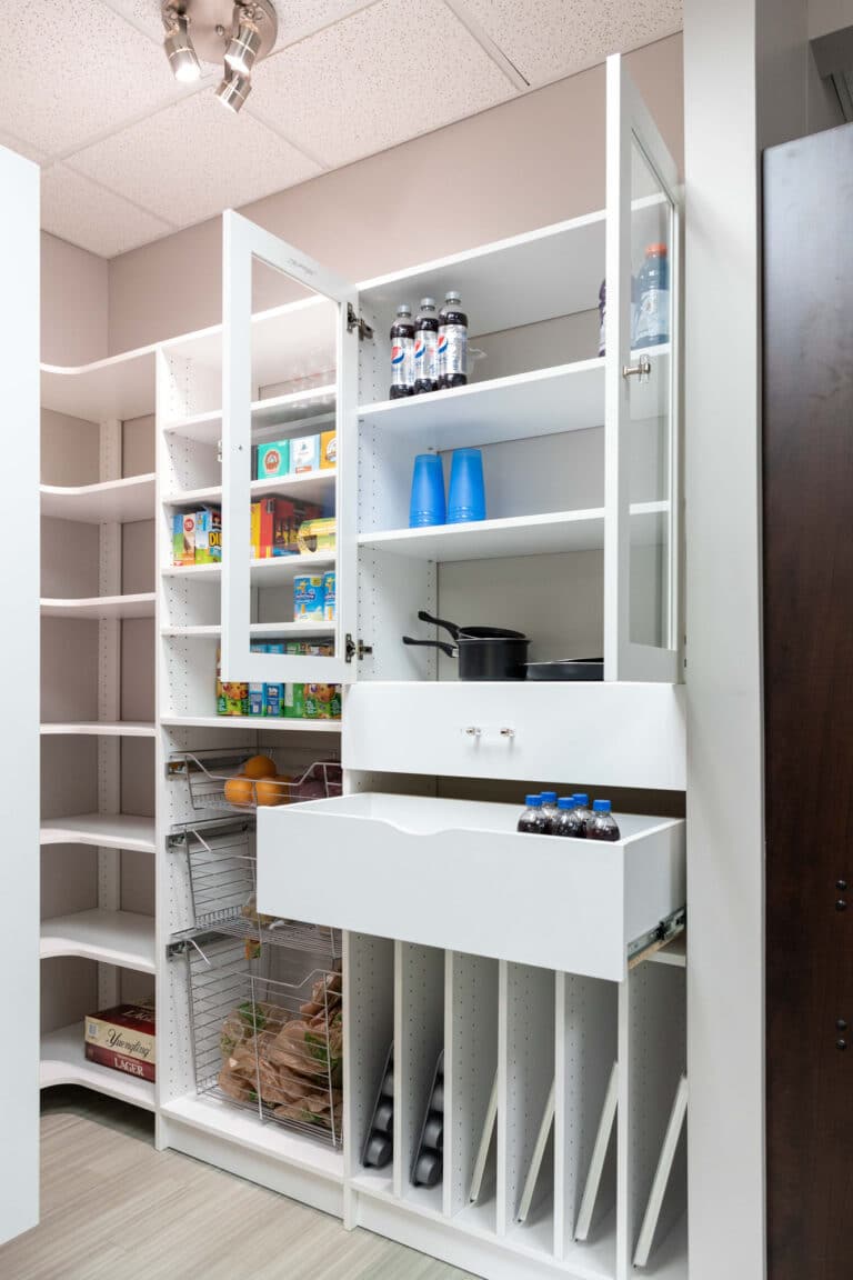 A kitchen pantry custom storage design with drawers and door opened