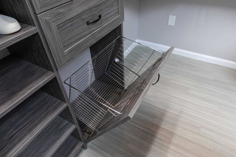 A custom closet organizer with a hidden basket drawer
