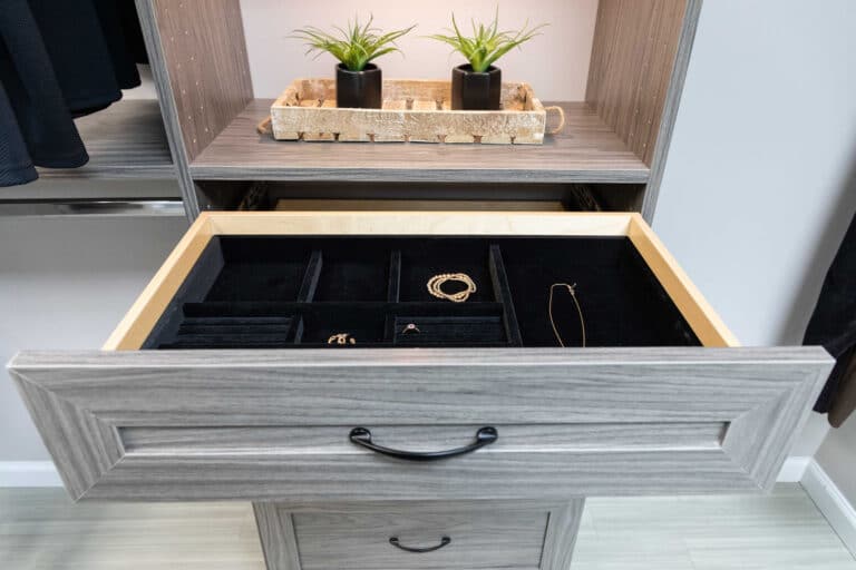 A custom closet installation with an open drawer