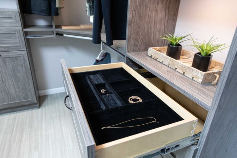 A custom closet installation with an open drawer