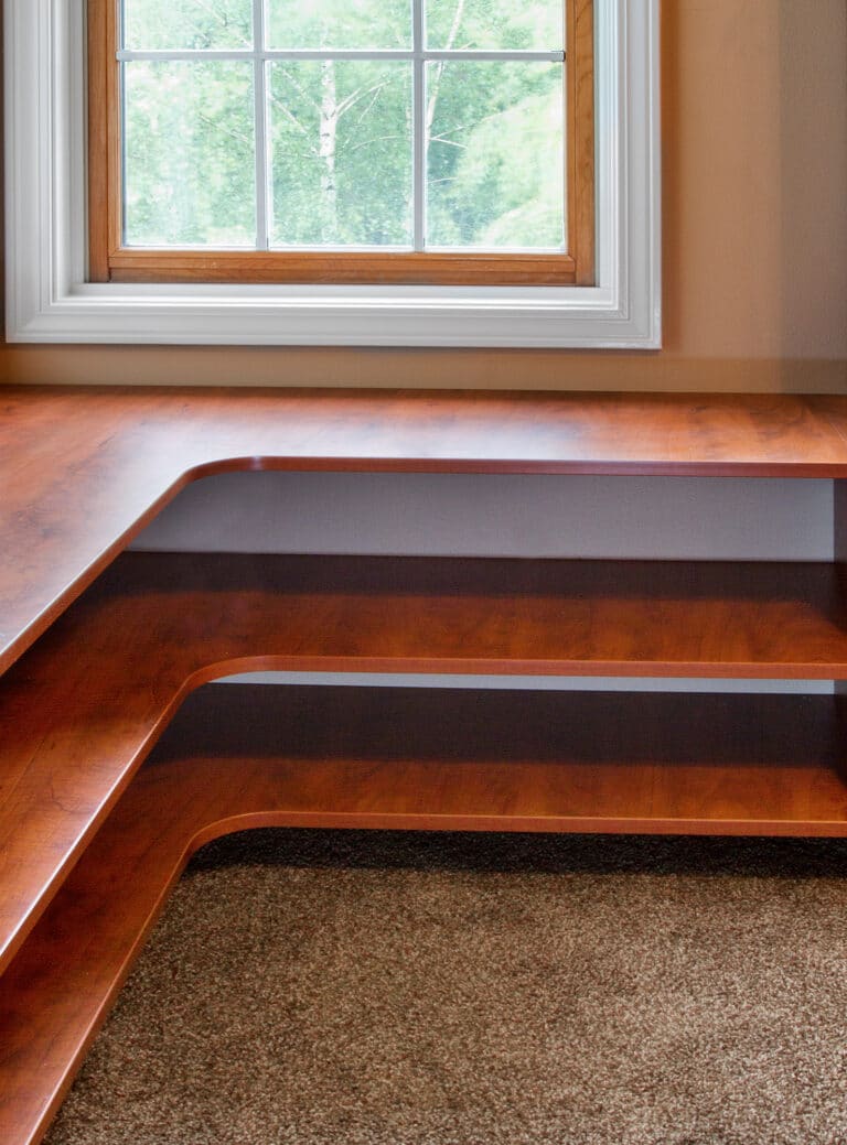 A master closet build out inside of a modern home with shelving that bends 90 degrees