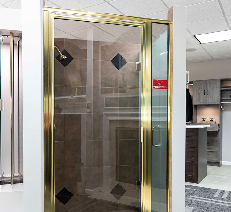 A brass framed glass shower door