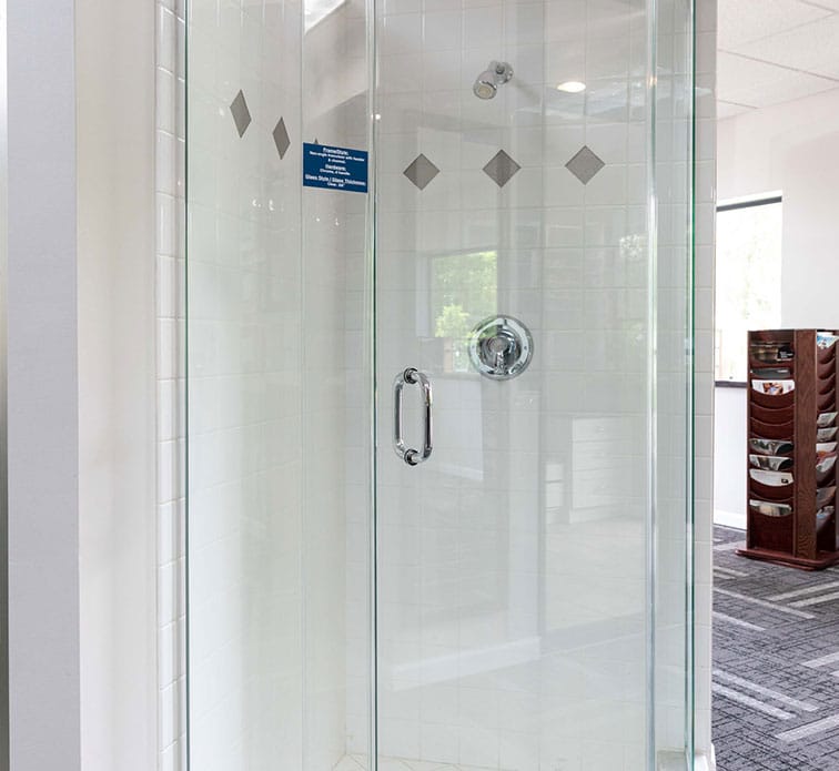 A neo-angle frameless shower door with header and channel
