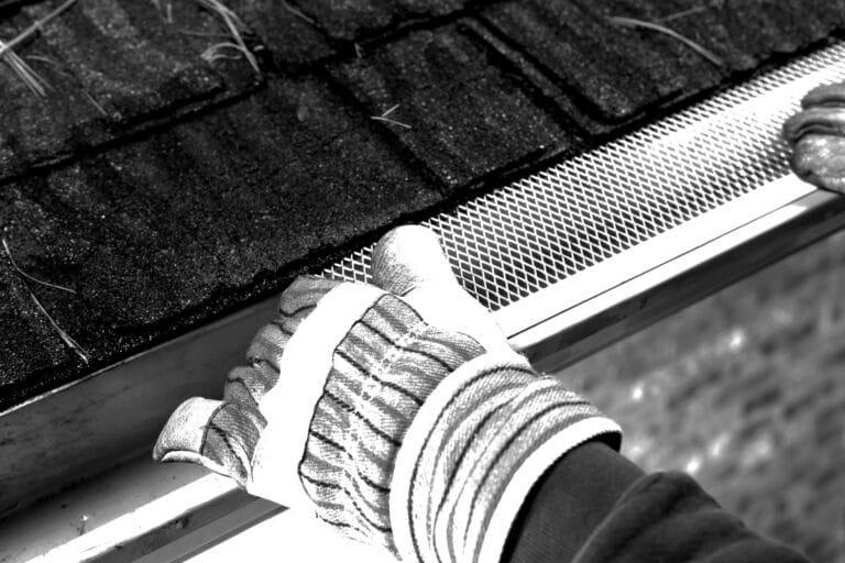 Worker Installing Rain Gutter Guard Leaf Shield