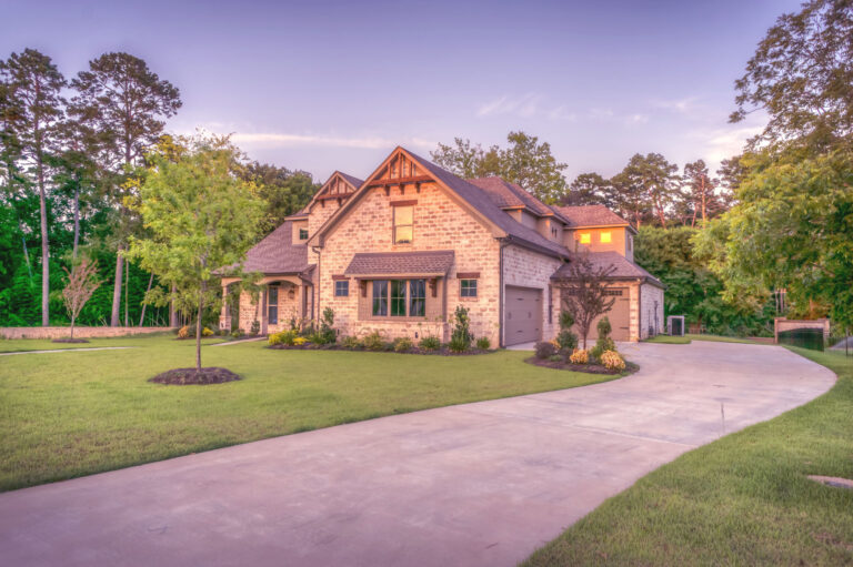 A brick home with a long driveway