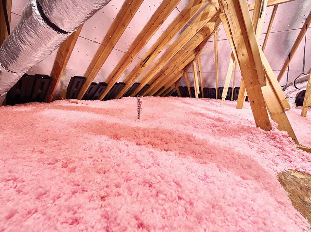 Loose fill insulation filling the area of a crawl space in a new construction project