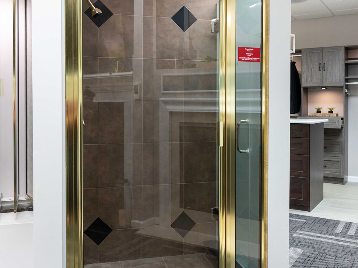 A brass framed shower door in the MIG Building Systems show room