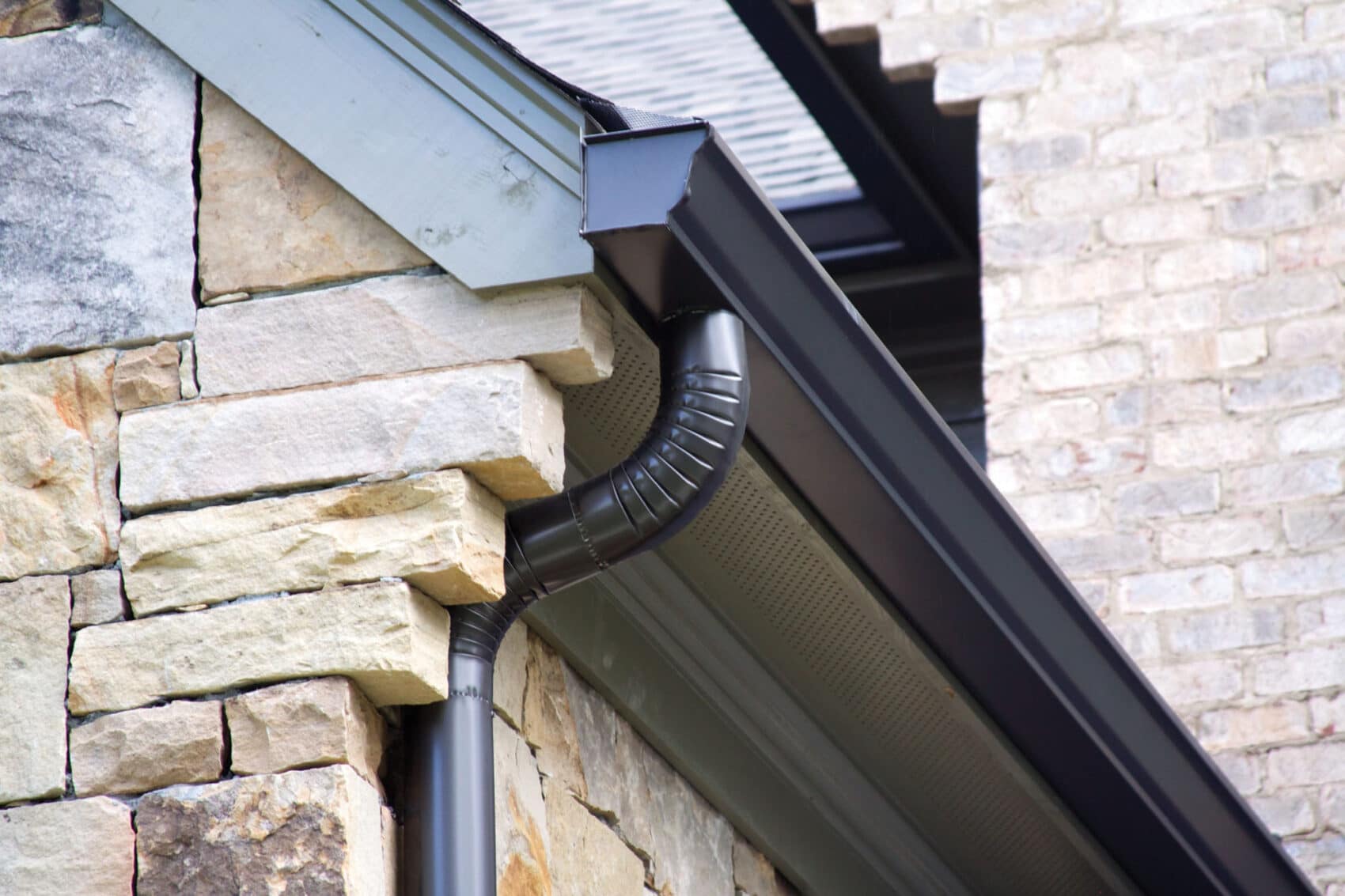 A k-style gutter with a round downpipe