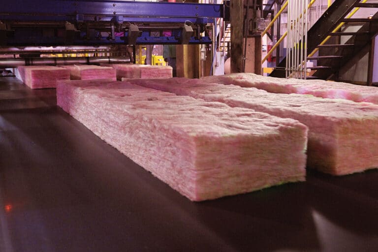 Unfaced insulation batts being produced at a production facility