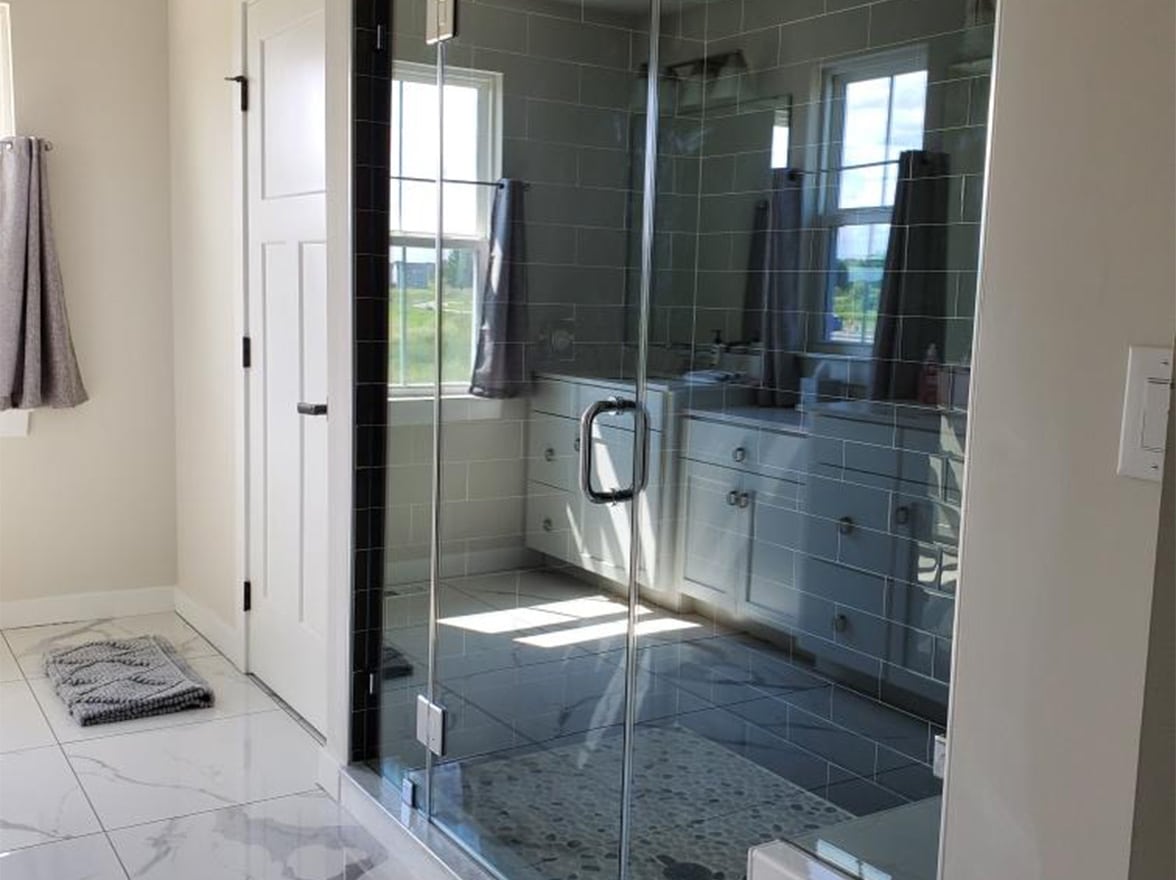 Glass shower doors in an updated bathroom.